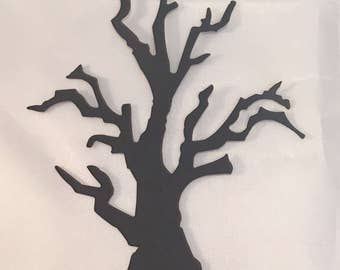 May include: A black silhouette of a bare tree with many branches. The tree's trunk is thick at the base and tapers upwards. The branches are thin and reach out in various directions. The tree is set against a white background.