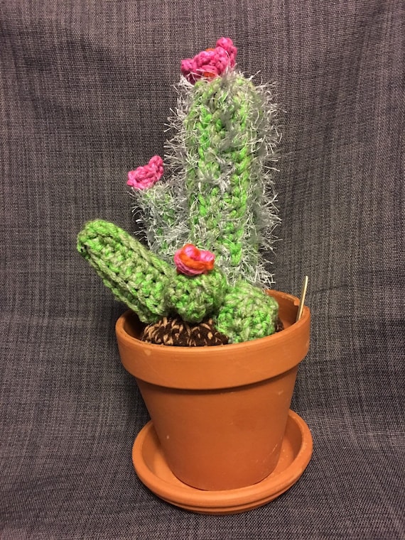 Handmade crocheted cactus with pink flowers