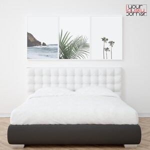 May include: Three framed prints of beach scenes. The first print shows a rocky coastline with waves crashing on the shore. The second print shows a close-up of palm leaves. The third print shows three palm trees against a white background.