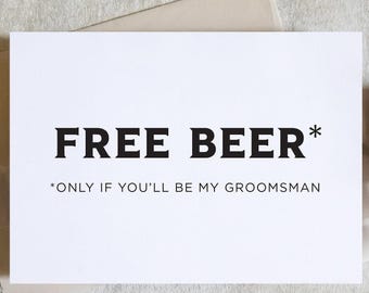 Puede incluir: Una tarjeta blanca con el texto "FREE BEER*" en letras negras en negrita. Debajo, un texto más pequeño dice "*ONLY IF YOU'LL BE MY GROOMSMAN". La tarjeta está sobre un fondo neutro con elementos decorativos.