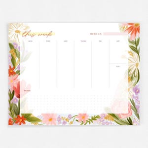 May include: A white weekly planner with a floral border. The planner has a section for each day of the week, a notes section, and a space to write the week number. The text "this week" is written in gold lettering at the top of the planner.