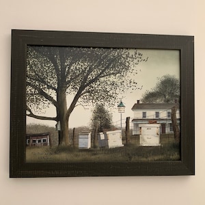 May include: A framed painting of a rural scene with a white farmhouse, a large tree, and several beehives. The painting is in a dark brown frame and has a white background. The text "The Birds and the Bees" is written in the bottom left corner of the painting.