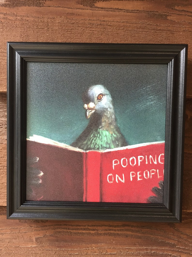 May include: A framed painting of a pigeon reading a book titled "POOPING ON PEOPLE". The book is red and the pigeon is gray and green.