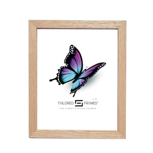 May include: A natural wood picture frame with a light brown finish. The frame is empty and has a white mount. The frame is showcasing a digital image of a purple and blue butterfly with black markings. The image includes the text "Tailored Frames" and "The Finest Picture Frames".