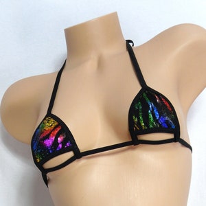 May include: A black bikini top with a rainbow zebra print on the cups. The bikini top has thin straps and a string tie closure. The bottom of the bikini is also visible, with a matching black string design.