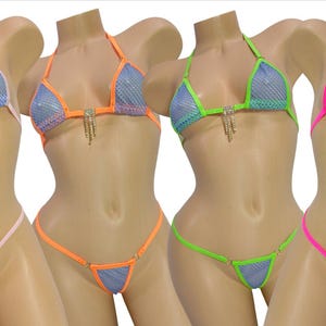 May include: Four mesh bikini sets in blue, orange, green, and pink. Each bikini features a triangle top and a thong bottom, with rhinestone accents. The swimsuits are displayed on mannequins.