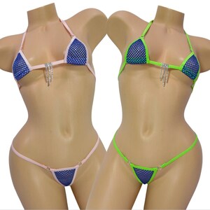 May include: Two bikini sets on mannequins. One is pink and blue, the other is green and blue. Both have a triangle top with a mesh design and a dangling rhinestone accent. The bottoms are a matching thong style.