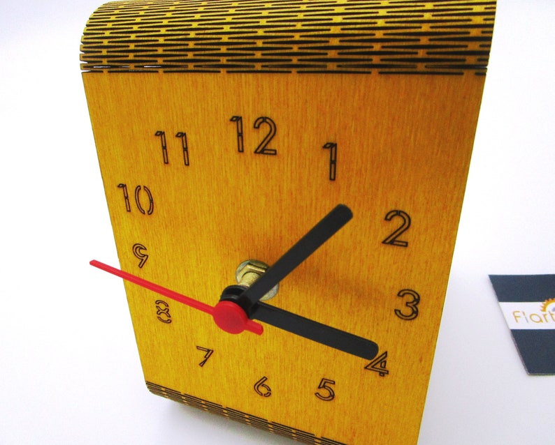 May include: A wooden clock with black numbers and hands. The clock face is yellow and the hands are black and red.