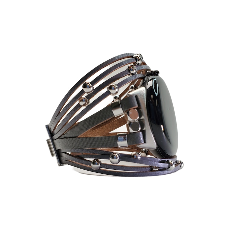 May include: A gray leather watch band with silver studs and a black watch face.