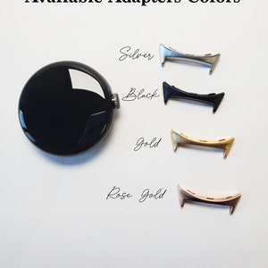 May include: Four watch band adapters in different colors: silver, black, gold, and rose gold. The adapters are metal and have a curved shape.