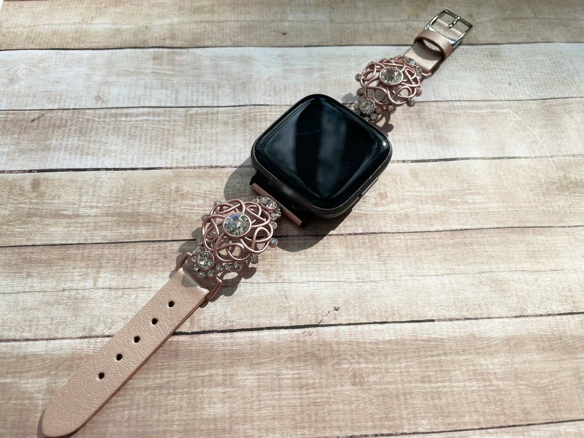 rose gold fitbit versa with different bands