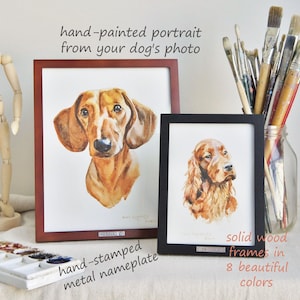 May include: Two hand-painted watercolor portraits of dogs in wooden frames. The larger portrait is of a dachshund, and the smaller portrait is of an Irish Setter. Both portraits have a hand-stamped metal nameplate.