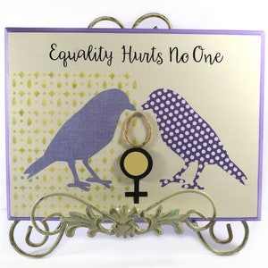 Wood Plaque Featuring  2 Birds Holding the Female Symbol Inscribed with &quot;Equality Hurts No One&quot;