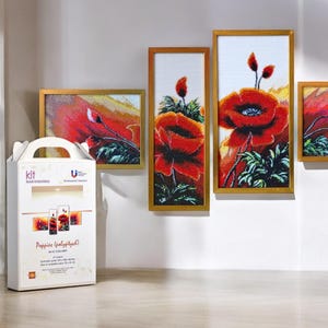 May include: A kit for diamond embroidery featuring four framed pictures of red poppies. The kit includes everything needed to create the artwork, including the canvas, beads, and instructions. The kit is packaged in a white box with the words "Kit Diamond Embroidery" and "Poppies Landscape" printed on it.