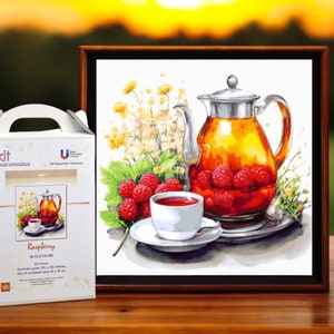 May include: A framed embroidery kit featuring a watercolor illustration of a teapot filled with raspberries, a teacup, and fresh berries. The kit box is white with the word "kit" and "Raspberry" printed on it.