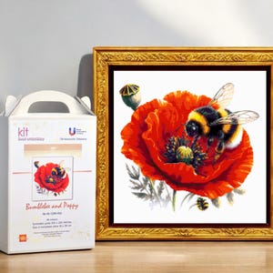 May include: A bead embroidery kit featuring a bumblebee and poppy flower. The kit includes all the materials needed to create a beautiful piece of art. The image shows a close-up of the finished product, which is framed in a gold frame.