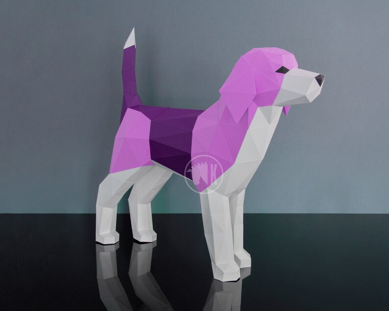 May include: A papercraft model of a beagle dog, with a pink and purple color scheme. The dog is standing on a black surface.