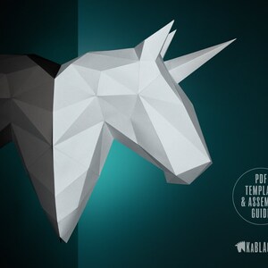 May include: A white and black papercraft unicorn head with a single horn. The unicorn is partially obscured by a black background. The text "PDF TEMPLATE & ASSEMBLY GUIDE" is in a circle on the right side of the image. The text "KABBLACKOUT" is in the lower right corner of the image.