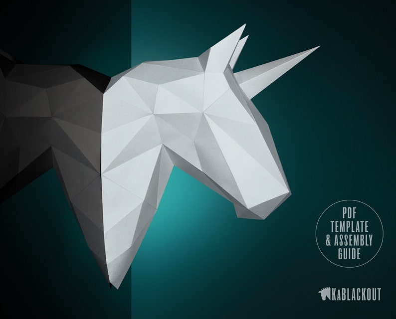 May include: A white and black papercraft unicorn head with a single horn. The unicorn is partially obscured by a black background. The text "PDF TEMPLATE & ASSEMBLY GUIDE" is in a circle on the right side of the image. The text "KABBLACKOUT" is in the lower right corner of the image.