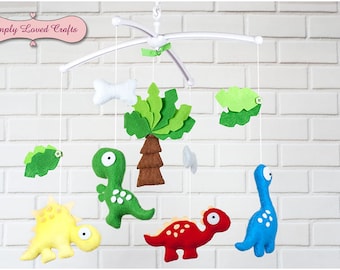 Baby Cot Musical Nursery Mobile with Dinosaurs, Bones and Green Leaves, Perfect Shower Gift and Nursery Decoration, Cot Arm Holder Included