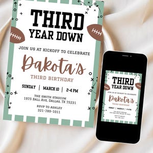 May include: An invitation for a third birthday celebration, featuring a football theme. The design includes the text "THIRD YEAR DOWN" and "Dakota's THIRD BIRTHDAY". The invitation is displayed on a white surface next to a smartphone displaying the same design.