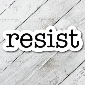 May include: White sticker with the word "resist" in black typewriter font.
