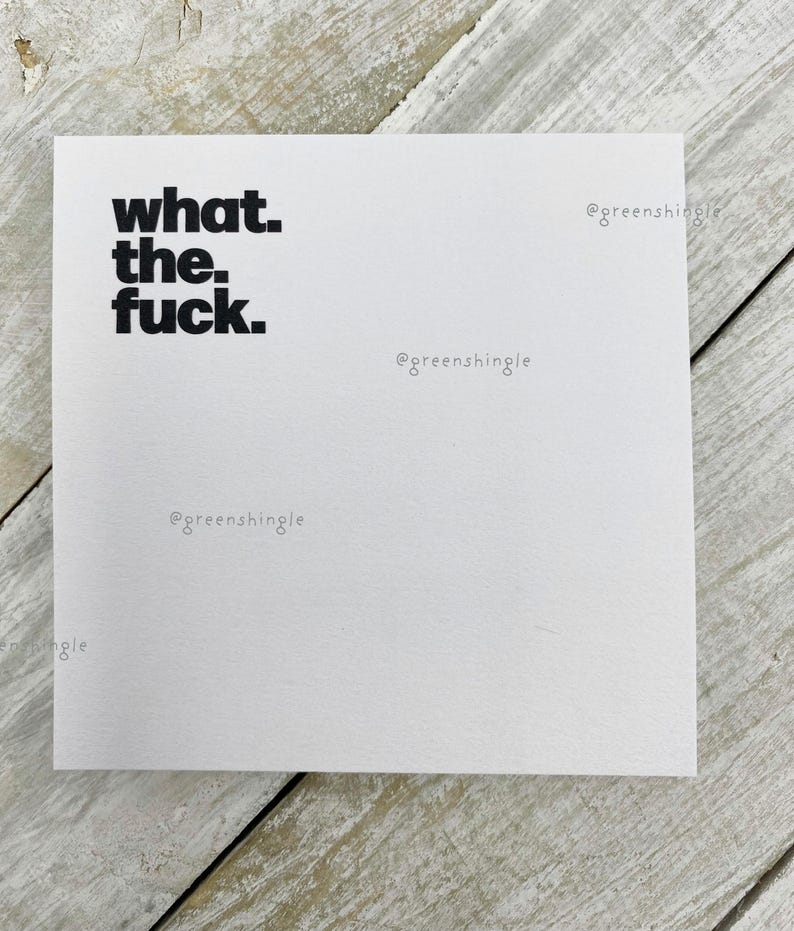 May include: White card with the phrase "what the fuck." printed in black text. The text "@greenshingle" is printed in black text in the bottom right corner of the card.