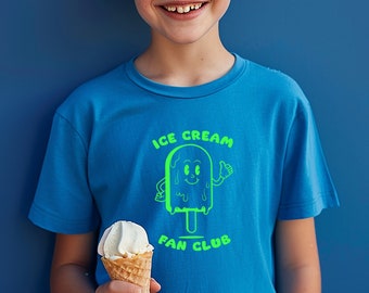 May include: A young boy wearing a blue t-shirt with a green ice cream graphic and the text "ICE CREAM FAN CLUB". He is holding a waffle cone with vanilla ice cream.