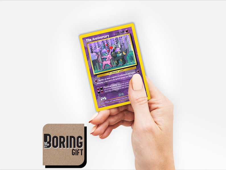 May include: A purple and yellow Pokemon card with a picture of two Pokemon, one pink and one black, with the text "The Anniversary" and "200 HP".