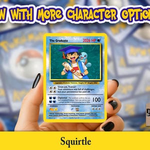 May include: A yellow trading card featuring the text "The Graduate" and a cartoon image of a graduate with a Squirtle. The card has a blue border and includes the text "2026 HP" and "100". The card is held in a hand with black nail polish. The text "NOW WITH MORE CHARACTER OPTIONS!" is at the top.
