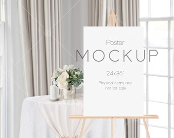 May include: A white poster mockup on an easel with the text "Poster Mockup 24x36" and "Physical items are not for sale". The poster is on a table with a white tablecloth and a vase of white flowers.