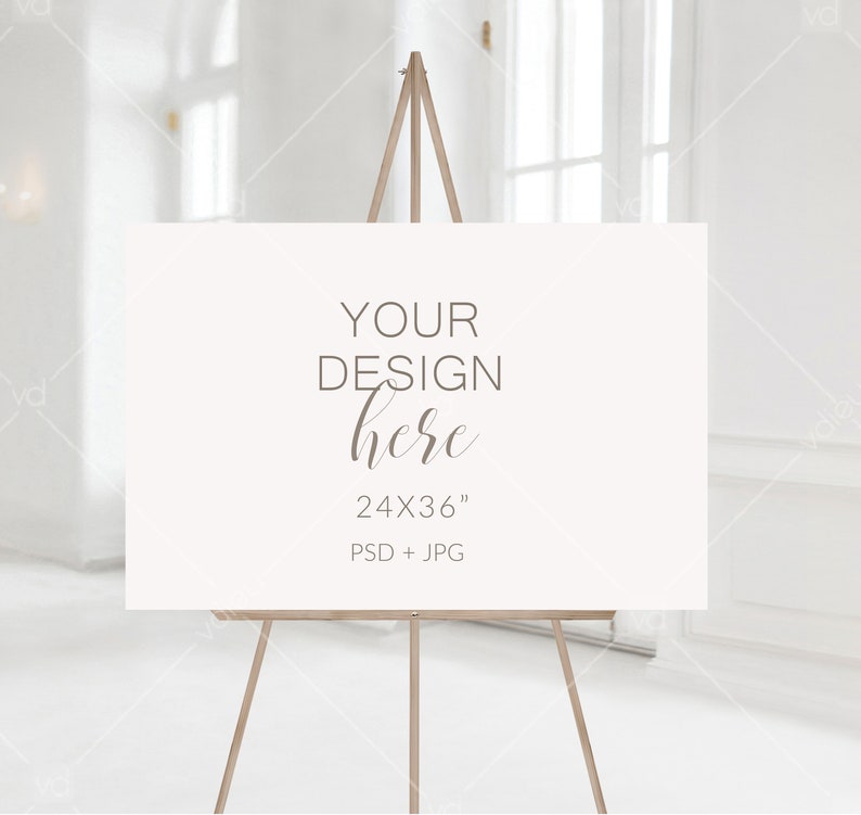 May include: A white sign on an easel with the text "YOUR DESIGN here 24X36" PSD + JPG"