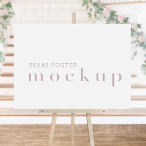 May include: A white poster mockup on a wooden easel, with the text "36x48 POSTER MOCKUP" in a light pink font.