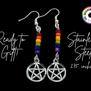 May include: A pair of silver-toned stainless steel dangle earrings featuring a pentagram charm suspended below a vertical row of rainbow-coloured beads. The text reads Ready To Gift, Stainless Steel, and 2.75 inches, with a logo in the corner.