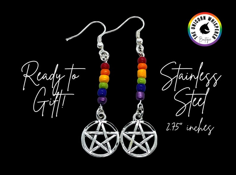 May include: A pair of silver-toned stainless steel dangle earrings featuring a pentagram charm suspended below a vertical row of rainbow-coloured beads. The text reads Ready To Gift, Stainless Steel, and 2.75 inches, with a logo in the corner.