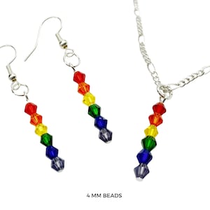 May include: A jewellery set consisting of two drop earrings and a pendant necklace, each featuring a vertical row of six faceted 4 mm beads in red, orange, yellow, green, blue, and purple, attached to silver-toned metal findings and a chain.