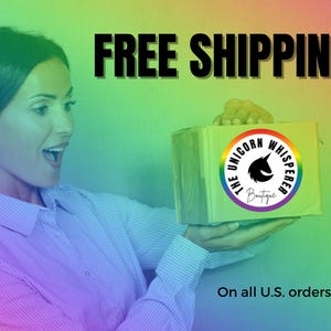 May include: A rectangular cardboard shipping box featuring a circular logo with a black unicorn silhouette and the text The Unicorn Whisperer Boutique, set against a vibrant rainbow gradient background with bold black text.