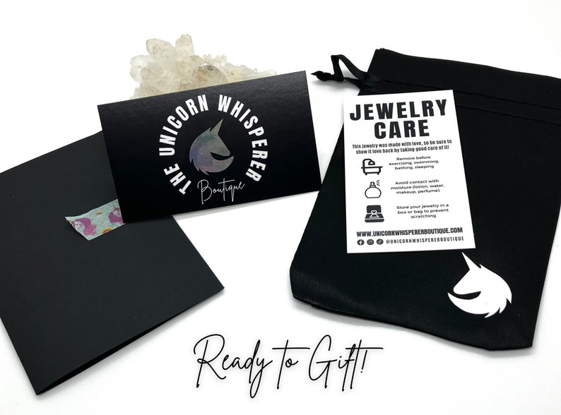 A black jewelry pouch with a white unicorn logo. Ready for gifting!