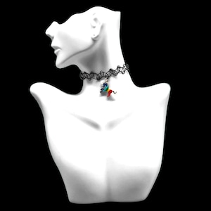 May include: A black choker necklace with a rainbow unicorn charm. The choker is made of elastic and has a stretchy fit.