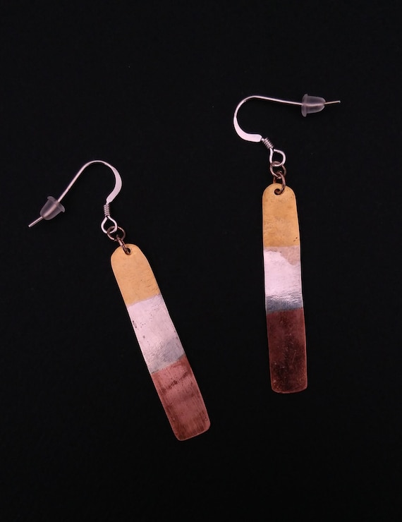 Hanging light earrings made of brass, copper and silver