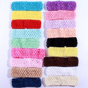 May include: A set of 18 crocheted headbands in various colors, including blue, yellow, red, pink, green, black, brown, white, and beige. The headbands are arranged in two rows of nine, with each headband stacked on top of the other.