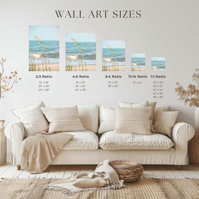 May include: A living room scene featuring a white sofa with beige pillows and a throw blanket. Above the sofa, various framed art prints of a beach scene are displayed, showcasing different aspect ratios and sizes, with text indicating dimensions in inches.