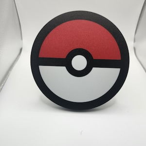 May include: A black and white circular sticker with a red, white, and black Pokeball design.