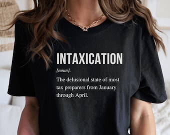 May include: Black t-shirt with the word "INTAXICATION" in white, along with a definition. The definition humorously describes the state of tax preparers from January through April. A gold necklace is visible.