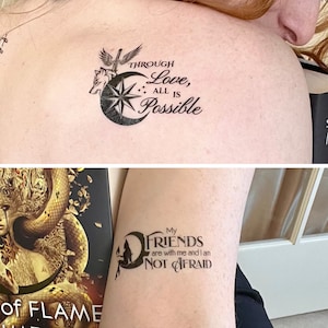 May include: Two temporary tattoos, one with a crescent moon, star, wolf, and sword with the text "Through Love, All Is Possible" and the other with a crescent moon, a figure, and the text "My Friends are with me and I am Not Afraid".