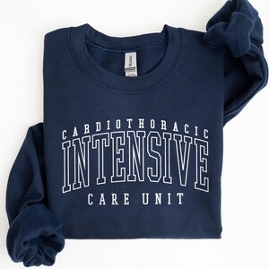 May include: Navy blue sweatshirt with white text that reads "Cardiothoracic Intensive Care Unit".