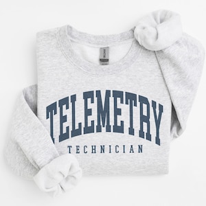 May include: Gray sweatshirt with the text "TELEMETRY TECHNICIAN" in a navy blue arch.