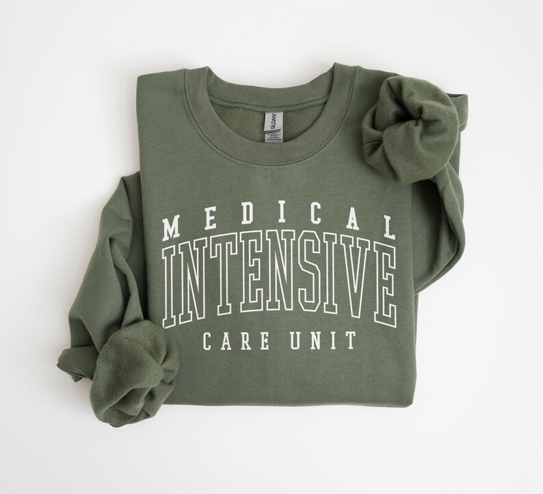 May include: A green sweatshirt with white text that reads "MEDICAL INTENSIVE CARE UNIT".