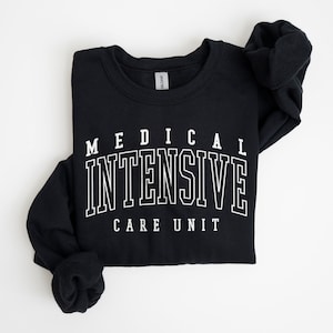 May include: Black sweatshirt with white text that reads "MEDICAL INTENSIVE CARE UNIT".