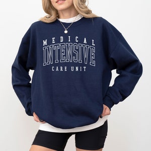 May include: A navy blue sweatshirt with the text "MEDICAL INTENSIVE CARE UNIT" in white.